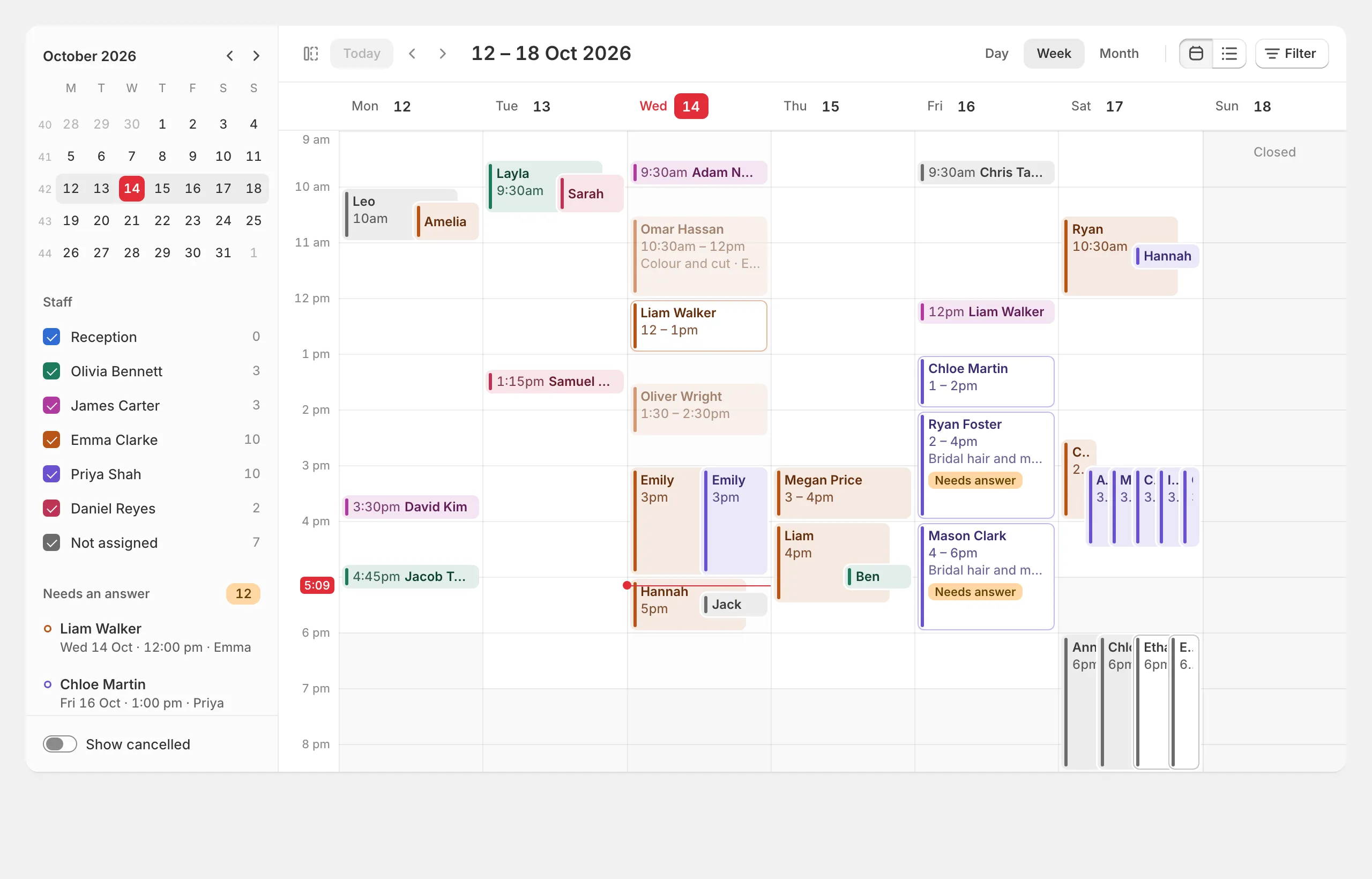 The Bookings calendar: a week with each person's bookings in their colour, the month and staff in the side column.